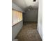 Well-lit attic featuring neutral carpet, a window, and a ceiling fan at 97 Willowick Dr, Lithonia, GA 30038