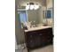 Bathroom features a vanity with dark wood cabinets and a large mirror at 97 Willowick Dr, Lithonia, GA 30038