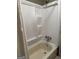 Standard bathtub with showerhead and white plastic enclosure at 97 Willowick Dr, Lithonia, GA 30038