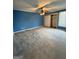 Large bedroom with blue walls, carpet, and a ceiling fan at 97 Willowick Dr, Lithonia, GA 30038