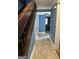 Light and airy hallway with wood staircase and blue walls at 97 Willowick Dr, Lithonia, GA 30038