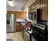 Kitchen featuring wooden cabinetry, stainless steel appliances, and dark countertops at 97 Willowick Dr, Lithonia, GA 30038