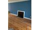 Living room features hardwood floors, fireplace and blue walls at 97 Willowick Dr, Lithonia, GA 30038