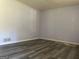 Simple living room with grey walls and wood-look floors at 266 Ridge Trl, Riverdale, GA 30274