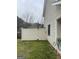 Backyard with a white privacy fence and green grass leading up to the side of a house at 1611 Cobbs Creek Ln, Decatur, GA 30032
