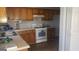Kitchen with wood cabinets, white appliances, and neutral countertops at 1611 Cobbs Creek Ln, Decatur, GA 30032