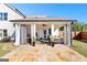 Covered patio with seating area, stone flooring, and curtains at 112 Twelve Parks Trail, Sharpsburg, GA 30277