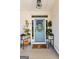 Inviting front entry with light blue door, potted plants, and a welcoming mat at 112 Twelve Parks Trail, Sharpsburg, GA 30277