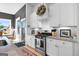 Bright kitchen featuring white cabinets, granite countertops, and gas cooktop at 112 Twelve Parks Trail, Sharpsburg, GA 30277