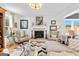 Living room with fireplace, comfortable armchairs, and a view into the dining area at 112 Twelve Parks Trail, Sharpsburg, GA 30277