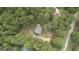 House nestled in a wooded area with a paved road nearby at 184 Elm St, Covington, GA 30014