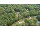 Aerial view of house on wooded lot, near other homes and a road at 184 Elm St, Covington, GA 30014