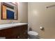 Clean bathroom with dark vanity and white toilet at 184 Elm St, Covington, GA 30014