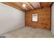 Simple bedroom with wood-paneled walls and a ceiling fan at 184 Elm St, Covington, GA 30014