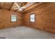 Bright bedroom featuring wood walls and ceiling, and neutral carpeting at 184 Elm St, Covington, GA 30014