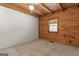 Cozy bedroom featuring wood-paneled walls and a ceiling fan at 184 Elm St, Covington, GA 30014