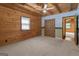 Charming bedroom with wood walls, ceiling fan, and two closets at 184 Elm St, Covington, GA 30014