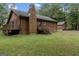 Back of the log cabin, showcasing a deck and backyard at 184 Elm St, Covington, GA 30014