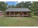 Charming log cabin home with a spacious front porch and detached garage at 184 Elm St, Covington, GA 30014