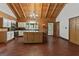 Bright kitchen featuring an island, dark wood cabinets and flooring at 184 Elm St, Covington, GA 30014