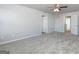 Spacious bedroom with plush carpeting, neutral walls, and a ceiling fan at 157 Aster Ave, Locust Grove, GA 30248