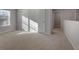 Bright bedroom with carpet and neutral walls at 157 Aster Ave, Locust Grove, GA 30248