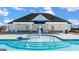 Community pool with a splash pad and covered seating area at 157 Aster Ave # 181, Locust Grove, GA 30248