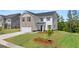 Charming two-story home featuring a brick and siding exterior with a well-maintained front lawn at 157 Aster Ave, Locust Grove, GA 30248