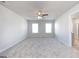 Spacious main bedroom with ceiling fan and plush carpeting at 157 Aster Ave, Locust Grove, GA 30248