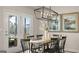 Bright dining room with wooden table and black chairs, near deck access at 603 Parnassus Rd, Locust Grove, GA 30248