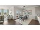 Open concept dining area with wooden table and black chairs, near living room at 603 Parnassus Rd, Locust Grove, GA 30248