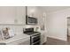 Modern kitchen features stainless steel appliances and gray cabinets at 603 Parnassus Rd, Locust Grove, GA 30248
