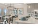 Modern kitchen with breakfast bar, and dining area with a chandelier at 603 Parnassus Rd, Locust Grove, GA 30248