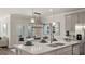 Modern kitchen island with white cabinets and quartz countertops at 603 Parnassus Rd, Locust Grove, GA 30248