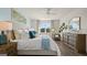 Main bedroom with light blue accent wall and a large bed at 603 Parnassus Rd, Locust Grove, GA 30248
