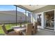 Enjoy this screened porch with outdoor seating and backyard access at 603 Parnassus Rd, Locust Grove, GA 30248