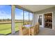 Enjoy this screened porch with dining area and view of the backyard at 761 Mryica Parnassus Rd, Locust Grove, GA 30248