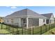 Well-maintained backyard with a screened porch, fenced perimeter, and lush green lawn at 592 Parnassus Rd, Locust Grove, GA 30248