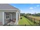 Spacious backyard featuring a screened porch, black fence, and scenic views of the surrounding area at 592 Parnassus Rd, Locust Grove, GA 30248