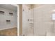 Bathroom with walk-in shower and shelving at 592 Parnassus Rd, Locust Grove, GA 30248