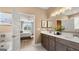 Bright bathroom showcases double sinks, quartz countertops, and a view into the bedroom at 592 Parnassus Rd, Locust Grove, GA 30248