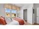 Bedroom featuring a large window with a view of the outdoors and an adjacent closet with double doors at 592 Parnassus Rd, Locust Grove, GA 30248