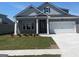 Charming one-story home featuring gray brick, white trim, and a two-car garage at 592 Parnassus Rd, Locust Grove, GA 30248