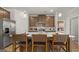 Well-equipped kitchen featuring stainless appliances, a large island with bar seating, and modern fixtures at 592 Parnassus Rd, Locust Grove, GA 30248
