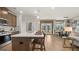 Bright kitchen with island seating flows into the dining and living areas, ideal for entertaining at 592 Parnassus Rd, Locust Grove, GA 30248