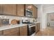 Gourmet kitchen with stainless steel stove and microwave, with quartz countertops and stylish backsplash at 592 Parnassus Rd, Locust Grove, GA 30248