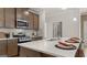Beautiful kitchen with large island, stainless steel appliances, quartz countertops, and stylish backsplash at 592 Parnassus Rd, Locust Grove, GA 30248