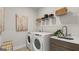 Laundry room features new washer and dryer, shelving, and a utility sink at 592 Parnassus Rd, Locust Grove, GA 30248