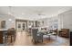 Open-concept living room and dining room with lots of natural light, a ceiling fan and hardwood floors at 592 Parnassus Rd, Locust Grove, GA 30248