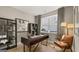 Stylish home office with sleek desk, modern shelving, and abundant natural light from a large window at 592 Parnassus Rd, Locust Grove, GA 30248